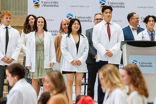MIKE DEAL / WINNIPEG FREE PRESS
Jessica Li (centre) and her brother Jeffrey Li (right) during the White Coat Ceremony.
Family, friends and medical dignitaries gather in the Brodie Centre Atrium, Bannatyne Campus, 727 McDermot Avenue, for the University of Manitoba&#x2019;s Inaugural Day Exercises of the largest medical class in University of Manitoba history, the Class of 2027. The Max Rady College of Medicine will see 125 incoming medical students this coming year up from 110 students in recent years. During the event the new students take part in the White Coat Ceremony and recite the Physician&#x2019;s Pledge.
See Tessa Adamski story 
230823 - Wednesday, August 23, 2023.