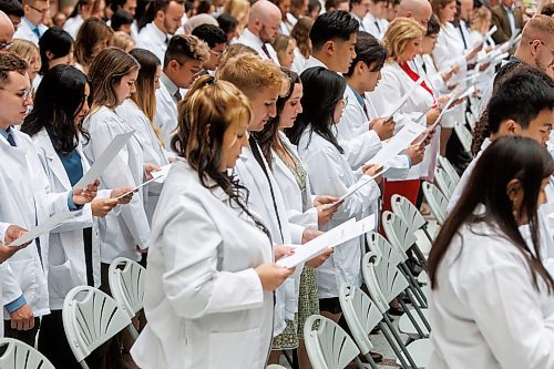 MIKE DEAL / WINNIPEG FREE PRESS
Students recite the Physician&#x2019;s Pledge during the Inaugural Day Exercises.
Family, friends and medical dignitaries gather in the Brodie Centre Atrium, Bannatyne Campus, 727 McDermot Avenue, for the University of Manitoba&#x2019;s Inaugural Day Exercises of the largest medical class in University of Manitoba history, the Class of 2027. The Max Rady College of Medicine will see 125 incoming medical students this coming year up from 110 students in recent years. During the event the new students take part in the White Coat Ceremony and recite the Physician&#x2019;s Pledge.
See Tessa Adamski story 
230823 - Wednesday, August 23, 2023.