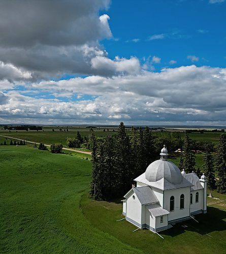 The sun shines through a break in fast-moving clouds to illuminate the St. Nicholas Ukrainian Catholic Church in Keld, Manitoba, southwest of Dauphin, on a windy and rainy day. The church was built in 1919-20.  (Tim Smith/The Brandon Sun)