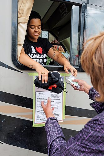 MIKE DEAL / WINNIPEG FREE PRESS
Ally Seidlitz hands over supplies to a participant at the Sunshine House RV or MOPS (Mobile Overdose Prevention Site) at the location in the parking lot of 631 Main Street.
See Malak Abas and Katrina Clarke story
230816 - Wednesday, August 16, 2023.