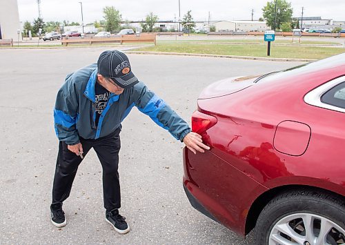 Mike Thiessen / Winnipeg Free Press 
Robert Shuster points out the damage sustained to his car as a result of Thursday night&#x2019;s hailstorm. With a looming MPI strike, he expects some delays in the claim process but isn&#x2019;t overly concerned about it. For Tyler Searle. 230825 &#x2013; Friday, August 25, 2023