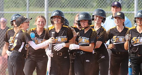 Brynne Shiels (18) of the Westman Storm, shown with a bat in her hand, celebrates with her teammates after her walk-off home run led to a mercy-rule victory over the Bonivital Bolts at Ashley Neufeld Softball Complex on Friday during Softball Manitoba&#x2019;s under-13 AA provincial championship. (Perry Bergson/The Brandon Sun)
Aug. 25, 2023