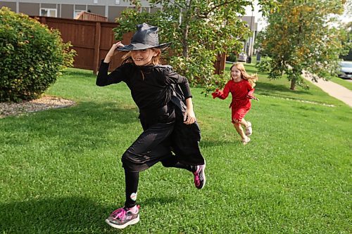 25082023
Siblings Olivia, Lily and Landon (not shown) Taphorn play outside their home in Halloween costumes on a sunny Friday afternoon. 
(Tim Smith/The Brandon Sun)