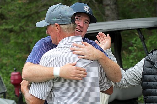 Josh McPhail hugs his dad, Ray, after winning the Tamarack golf tournament men's title at Clear Lake Golf Course on Saturday. (Thomas Friesen/The Brandon Sun)