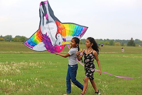 Some local youth prepare their unicorn-theme kite for flight Saturday afternoon at the Riverbank Discovery Centre. (Kyle Darbyson/The Brandon Sun)