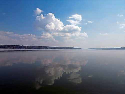 28082023
Clouds are reflected in Pelican Lake on a sunny Monday afternoon. 
(Tim Smith/The Brandon Sun)