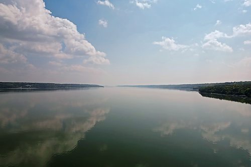 28082023
Clouds are reflected in Pelican Lake on a sunny Monday afternoon. 
(Tim Smith/The Brandon Sun)