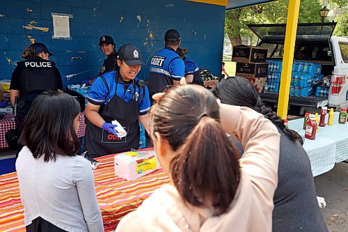 29082023
Brandon Police Service Community Cadet Alyssa Mendoza serves hotdogs to Brandonites at Stanley Park on Tuesday during a free BBQ hosted by BPS.
(Tim Smith/The Brandon Sun)