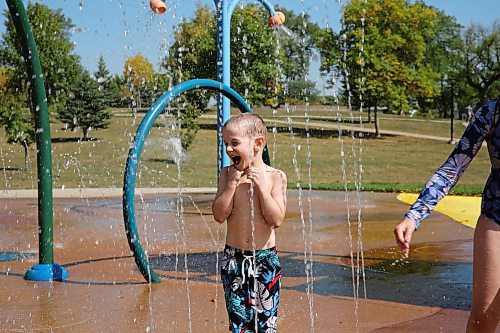 Six year old Thaddeus laughs as he moves through the stationary water spouts at Rideau Splash Park in Brandon on Wednesday. He spent the day at the water park with his siblings and his mom, who asked the Sun to use his first name only. (Michele McDougall/The Brandon Sun)