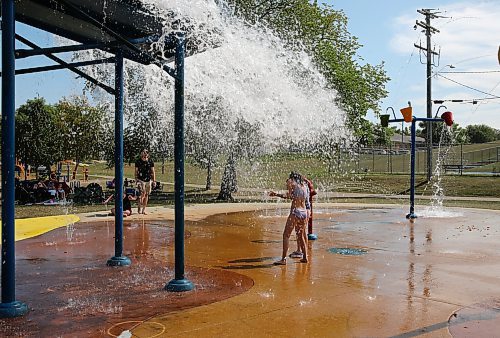 Two girls brace themselves for the big bucket splash at Rideau Splash Park Wednesday afternoon in Brandon. Splash parks and pools in the city will continue operating through Sunday. See story on Page A2. (Michele McDougall/The Brandon Sun)