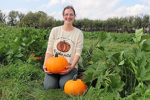 Kristelle Harper showcases some of the pumpkins that her team has been growing west of Brandon during a tour of the Solar Nutrition farm Thursday afternoon. Solar Nutrition's U-Pick pumpkin patch will be open to the public starting Sept. 16. (Kyle Darbyson/The Brandon Sun)