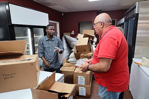 Trinity Meat & Food Place co-founder Olatoye Olaosebikan attending to a customer. (Abiola Odutola/The Brandon Sun)