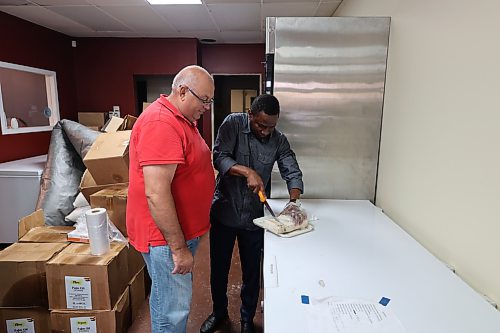 Trinity Meat & Food Place co-founder Olatoye Olaosebikan attending to a customer. (Abiola Odutola/The Brandon Sun)