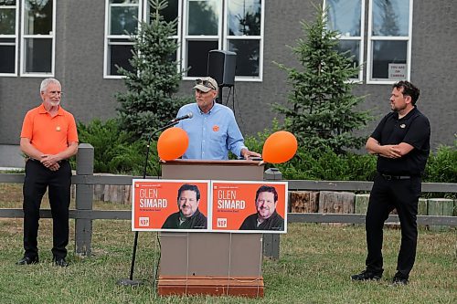 Former Brandon East NDP MLA Drew Caldwell (centre) gives an introductory speech as Glen Simard (right) and Quentin Robinson (left) look on at the opening of Simard's campaign office on Thursday at the East End Community Centre. (Colin Slark/The Brandon Sun)