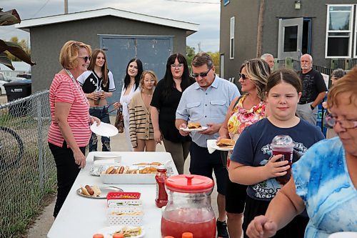 Guests line up for burgers and hotdogs at Brandon East NDP candidate Glen Simard's campaign office opening at the East End Community Centre on Thursday. (Colin Slark/The Brandon Sun)