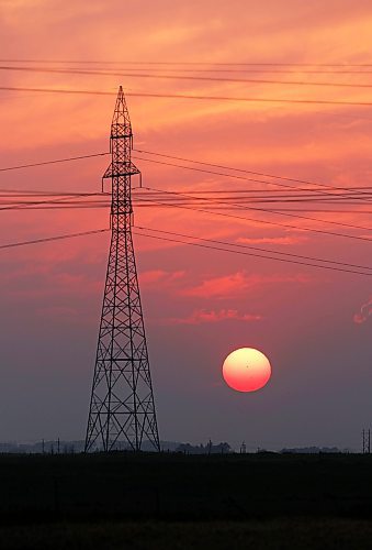 The setting sun, as seen from a wheat field west of Brandon in recent weeks, is made red by the ongoing smoke in the atmosphere from burning wildfires. (Matt Goerzen/The Brandon Sun)