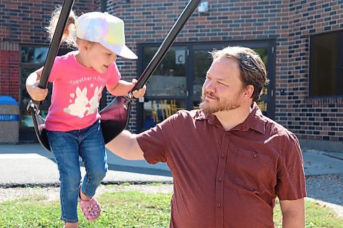 Brandon and District Labour Council president Kirk Carr plays with his daughter Maya outside King George School on Friday afternoon. Carr decided to run for a seat on the Brandon School Division board of trustees for the second year in a row after witnessing an escalation of anti-LGBTQ+ rhetoric over the last couple months. (Kyle Darbyson/The Brandon Sun)