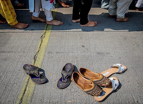 JOHN WOODS / WINNIPEG FREE PRESS
Members of the Manitoba Sikh community remove their shoes and line up to place offerings at the Nagar Kirtan parade, an annual celebration of the Guru Granth Sahib, the holy scripture of Sikhism in downtown Winnipeg Sunday, September 3, 2023. 

Re: Abas