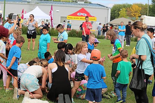 Some local youth scramble to pick up some sweets during a “candy toss” that took place at UFCW Local 832 headquarters in Brandon during Labour Day. (Kyle Darbyson/The Brandon Sun)