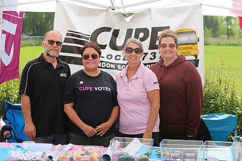 Members of the Canadian Union of Public Employees — including Jamie Rose (CUPE Local 737 president), April McDonald (CUPE national servicing representative), Candice Rose (CUPE Local 737 support staff) and Candace Saunders (CUPE Local 737 vice-president) — pose for a group photo during a Labour Day barbecue that took place at UFCW Local 832’s headquarters in Brandon. (Kyle Darbyson/The Brandon Sun)