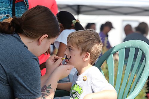 Four-year-old Grayson Kolody receives a painted-on mustache during the Brandon and District Labour Council’s Labour Day festivities. (Kyle Darbyson/The Brandon Sun)