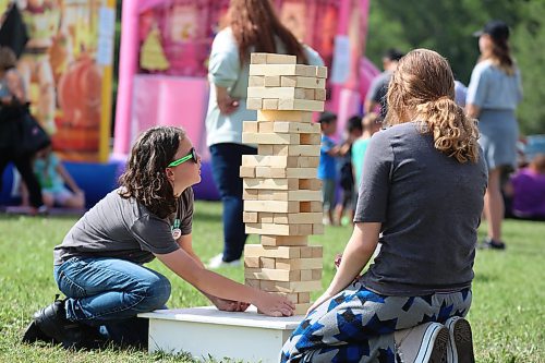 Cyrus Enns and Emma Kutzan take part in a game of Jenga during the Brandon and District Labour Council’s Labour Day festivities. (Kyle Darbyson/The Brandon Sun)