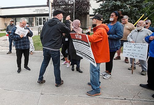 JOHN WOODS / WINNIPEG FREE PRESS
A person with an opposing point of view confronts and yells at people gathered in support of a suspended school trustee at Louis Riel School Division office on Monterey Road in Winnipeg Tuesday, September 5, 2023. Francine Champagne, a school trustee, was suspended recently for allegedly posting controversial content.

Reporter: macintosh