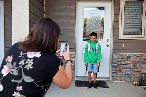 06092023
Viviana Rodriguez takes first-day-of-school photos of her son Bruno Zhou-Rodriguez on the front steps of their home before his first day of grade four at Maryland Park School on Wednesday morning. 
(Tim Smith/The Brandon Sun) 