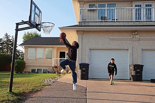 06092023
Mateo Landaverde-Cameron dunks the ball while playing basketball with his brother Nico before their first day back to school on Wednesday morning. Mateo is in grade eight and Nico is in grade four. 
(Tim Smith/The Brandon Sun) 