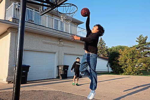06092023
Mateo Landaverde-Cameron dunks the ball while playing basketball with his brother Nico before their first day back to school on Wednesday morning. Mateo is in grade eight and Nico is in grade four. 
(Tim Smith/The Brandon Sun) 