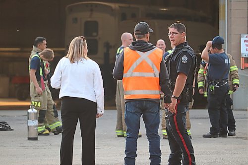 Local first responders chat with city workers following an explosion that took place at the Civic Services Complex Thursday evening in Brandon. (Kyle Darbyson/The Brandon Sun)