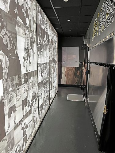 The hallway between the dressing room and the dry room also features team history. The players leave the room to come down to the ice through an electronic door by the mat on the floor. (Perry Bergson/The Brandon Sun)