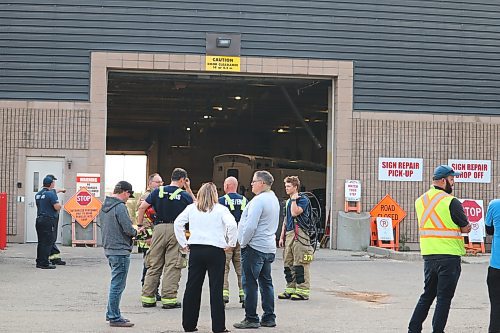 Local first responders and city officials gather outside the east-side entrance of Brandon's Civic Services Complex Thursday evening after an explosion rocked the building and sent one employee to the hospital. (Kyle Darbyson/The Brandon Sun) 