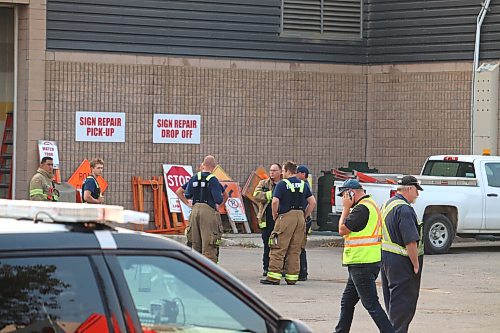 Local first responders and city officials gather outside the east-side entrance of Brandon's Civic Services Complex Thursday evening after an explosion rocked the building and sent one employee to the hospital. (Kyle Darbyson/The Brandon Sun) 