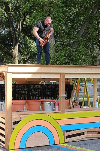 Brandon University alumnus Sean Irvine plays the saxophone on top of a drink stand Friday evening during the first day of the inaugural Hatch music festival. Irvine would go on to perform at the festival main stage later that night alongside the band Touching. (Kyle Darbyson/The Brandon Sun) 