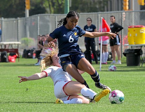 Keashae Masters of the Brandon University Bobcats is tackled by St. Boniface Les Rouges defender Tara Boulanger during their MCAC women's soccer season opener at the Healthy Living Centre field on Saturday. (Thomas Friesen/The Brandon Sun)