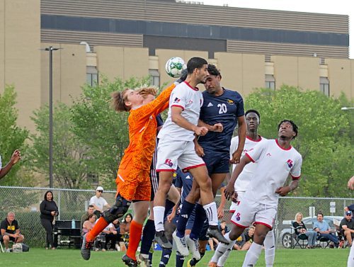 The Brandon University Bobcats and St. Boniface Les Rouges battle for an aerial ball in front of USB's net in their MCAC men's soccer season opener at the Healthy Living Centre field on Saturday. (Thomas Friesen/The Brandon Sun)