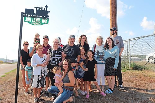 Members of the Lewis family pose for a group photo underneath a new street sign, "Jon Lewis Way," that was unveiled near Minnedosa's new Sunrise Credit Union Centre Saturday afternoon. Jon Lewis was one of the key figures who helped get this project off the ground and has contributed to various other sports initiatives in this community throughout his life. (Kyle Darbyson/The Brandon Sun)