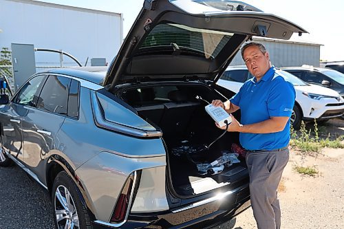 Murray Chevrolet Cadillac Buick GMC Brandon Dealer Principal Rich Pentney showing charging devices of the EV model of Cadillac Lyriq. (Abiola Odutola/The Brandon Sun)