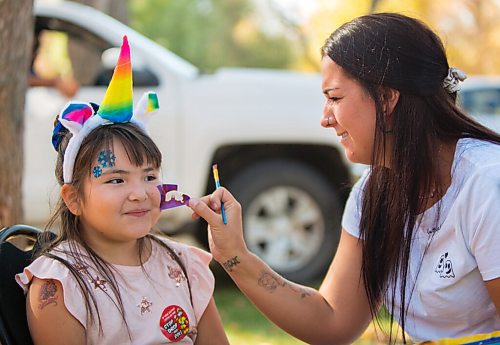 Norma Brown, 6, left, gets her face painted by Danielle Forton during last year's Souris Scarecrow Days. (Chelsea Kemp/The Brandon Sun)