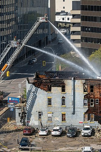 MIKE DEAL / WINNIPEG FREE PRESS
Winnipeg fire crews continue to pour water onto the remains of the closed Windsor Hotel which caught fire Wednesday morning.
230913 - Wednesday, September 13, 2023.