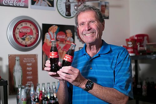 BROOK JONES / WINNIPEG FREE PRESS
Winnipegger Morris Glimcher, who was the executive director of the Manitoba High Schools Athletic Association for 40 years before retiring in 2016, shows off his Coca-Cola collection at his home in Winnipeg, Man., Wednesday, Sept. 13, 2023. Glimcher is pictured holding Coca-Cola bottles with labels that reads Share a Coke with Mo and Share a Coke with Morris. Glimcher is often referred to by his nickname Mo.