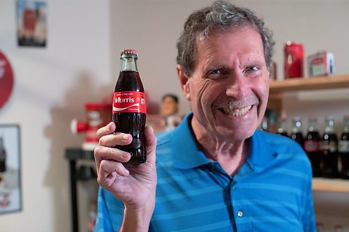 BROOK JONES / WINNIPEG FREE PRESS
Winnipegger Morris Glimcher, who was the executive director of the Manitoba High Schools Athletic Association for 40 years before retiring in 2016, shows off his Coca-Cola collection at his home in Winnipeg, Man., Wednesday, Sept. 13, 2023. Glimcher is pictured holding a Coca-Cola bottle with the label that reads Share a Coke with Morris.