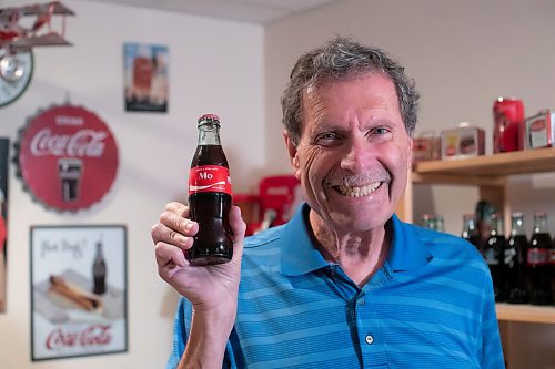 BROOK JONES / WINNIPEG FREE PRESS
Winnipegger Morris Glimcher, who was the executive director of the Manitoba High Schools Athletic Association for 40 years before retiring in 2016, shows off his Coca-Cola collection at his home in Winnipeg, Man., Wednesday, Sept. 13, 2023. Glimcher is pictured holding a Coca-Cola bottle with the label that reads Share a Coke with Mo. Glimcher is often referred to by his nickname Mo.