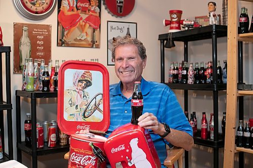 BROOK JONES / WINNIPEG FREE PRESS
Winnipegger Morris Glimcher, who was the executive director of the Manitoba High Schools Athletic Association from 1975 to 2016, is all smiles as he shows off his Coca-Cola collection of bottles and memorabilia at his home in Winnipeg, Man., Wednesday, Sept. 13, 2023. Glimcher is often referred to by his nickname Mo.