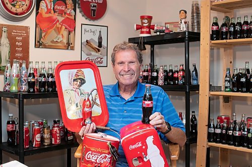 BROOK JONES / WINNIPEG FREE PRESS
Winnipegger Morris Glimcher, who was the executive director of the Manitoba High Schools Athletic Association from 1975 to 2016, is all smiles as he shows off his Coca-Cola collection of bottles and memorabilia at his home in Winnipeg, Man., Wednesday, Sept. 13, 2023. Glimcher is often referred to by his nickname Mo.