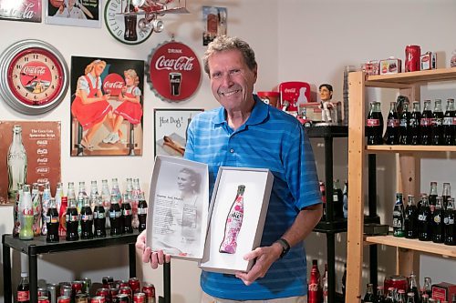 BROOK JONES / WINNIPEG FREE PRESS
Winnipeg resident Morris Glimcher, who was the executive director of the Manitoba High Schools Athletic Association from 1975 to 2016, is all smiles as he shows off his Coca-Cola collection of bottles and memorabilia at his home in Winnipeg, Man., Wednesday, Sept. 13, 2023. Glimcher is pictured holding one of 200 Diet Coke bottles issued in Canada that were signed by Canadian professional tennis and pickleball player Genie Bouchard, who created the pattern using her racquet and a paint-covered tennis ball as her palette in a live closed set outside of Montreal, Que. 