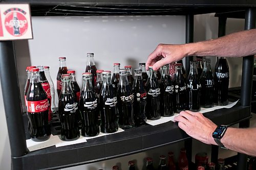 BROOK JONES / WINNIPEG FREE PRESS 
Morris Glimcher organizes some of his unopened Coca-Cola bottles from countries around the world, including Japan, China, Israel, Bulgaria and Ethiopia.