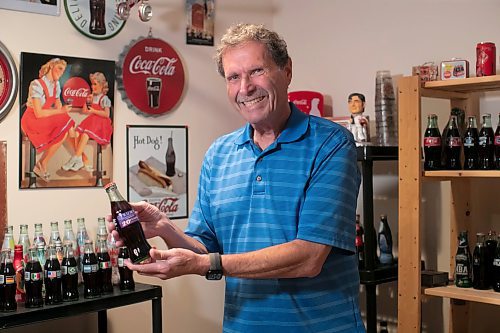 BROOK JONES / WINNIPEG FREE PRESS
Winnipegger Morris Glimcher, who was the executive director of the Manitoba High Schools Athletic Association from 1975 to 2016, shows off his Coca-Cola collection of bottles and memorabilia in his rec room at his home in Winnipeg, Man., Wednesday, Sept. 13, 2023. Glimcher has found unqiue bottles from around the world. He is pictured looking an unopened Coca-Cola bottle with the label featuring Trump - Hotels &amp; Casino Resorts - Celebrating 20 Years in Atlantic City. The Coca-Cola Company was founded in 1896 in Atlanta, Ga., and is sold in more than 200 countries worldwide.