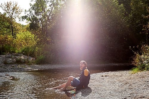 14092023
Janis Dutko of the Polonia area cools her feet in the shale-bed creek at Big Valley Park in the RM of Rosedale on a warm and sunny Wednesday. 
(Tim Smith/The Brandon Sun)